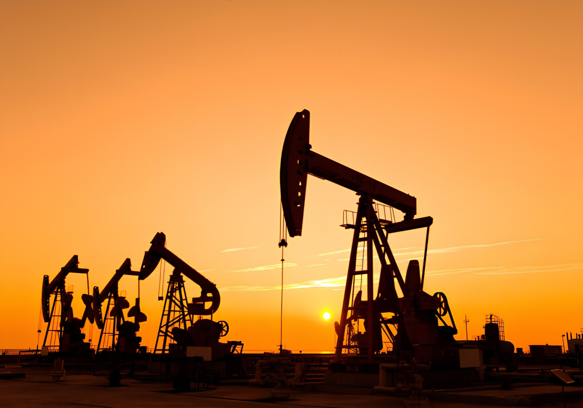 Oilfield pump jacks at sunset, illustrative photography